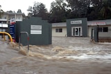 High water: flooding from Ithaca Creek inundates Red Hill businesses.