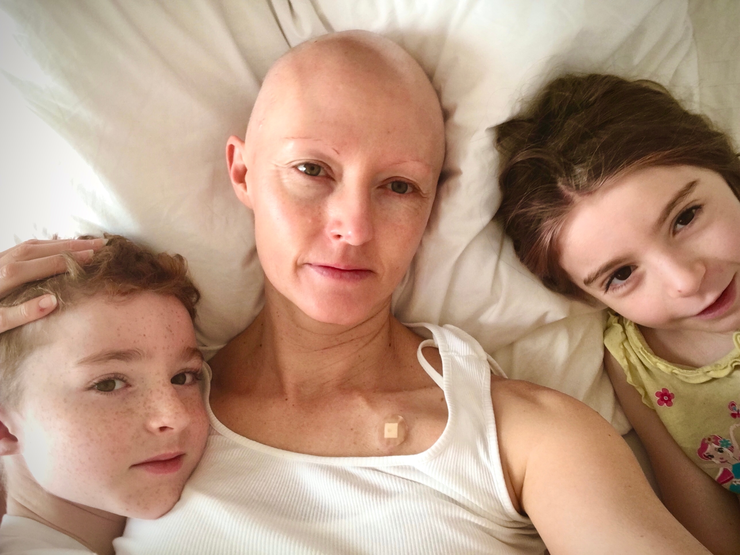 Mary Lloyd pictured with two of her children in 2020, when she had no hair. 