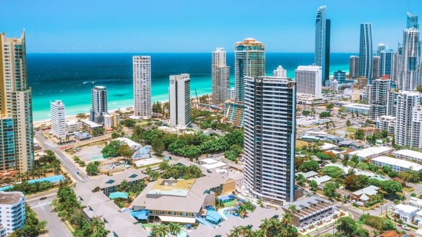 Bright sunny day showing high-rises and the ocean in the background.