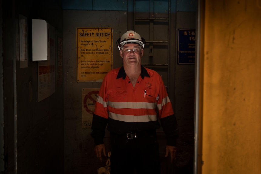 A man poses for a photo in a hard hat