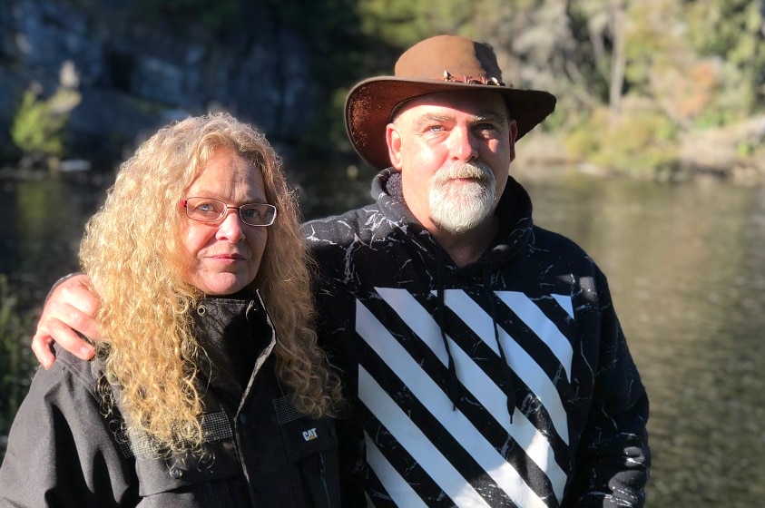 Couple from Tasmania's Loongana Valley standing near a river