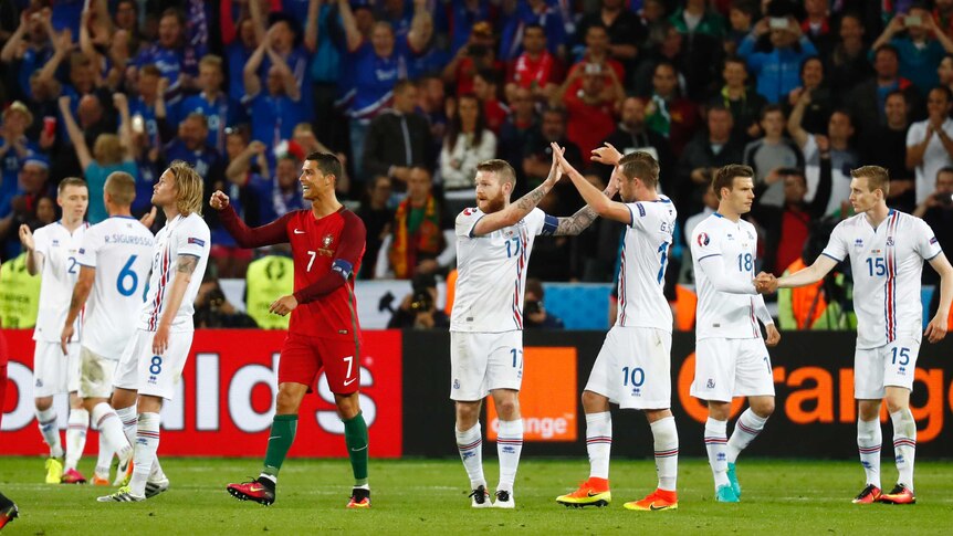 Portugal's Cristiano Ronaldo watches as Iceland players celebrate a 1-1 draw at Euro 2016.