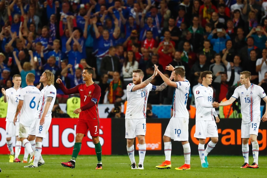 Portugal's Cristiano Ronaldo watches as Iceland players celebrate a 1-1 draw at Euro 2016.