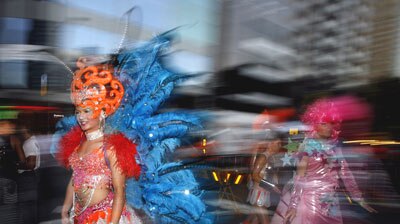 Participants dressed in colourful costumes prepare for the Gay and Lesbian Mardi Gras parade.