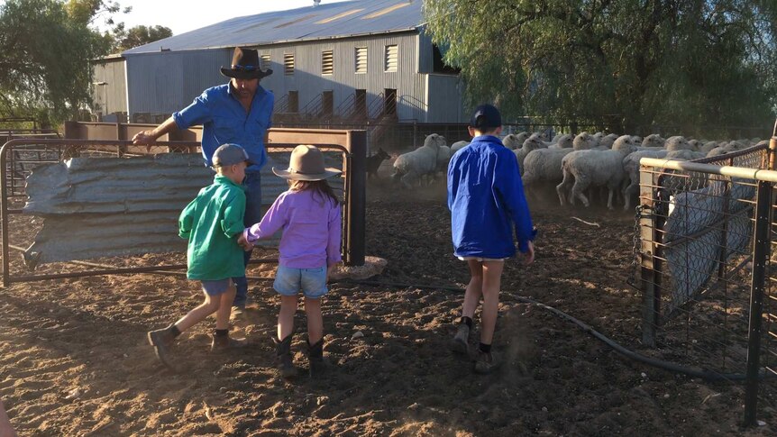 Kids helping their dad on the farm.