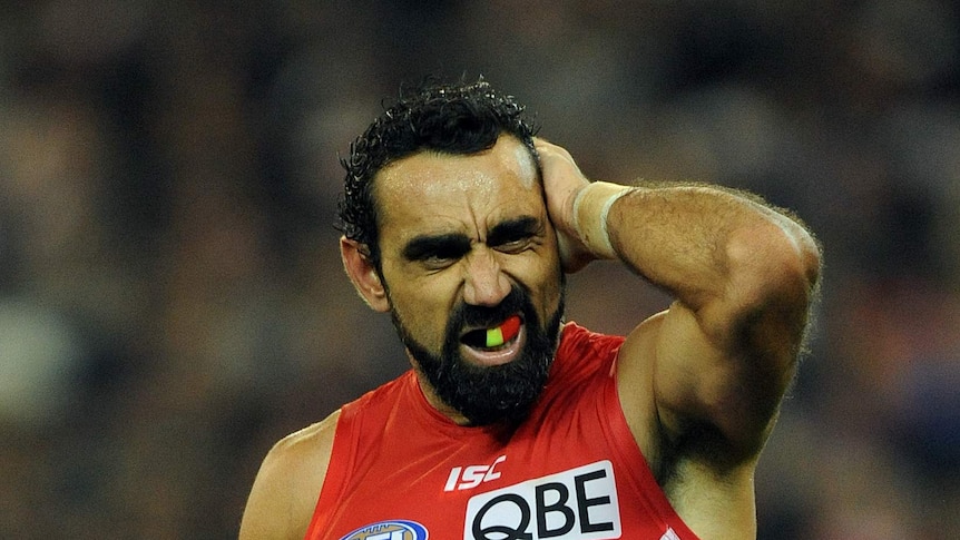 Goodes rubs his head at the G