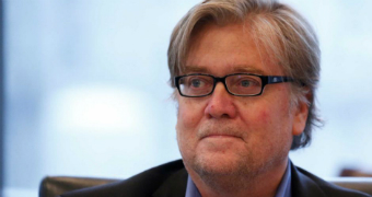 Stephen Bannon, wearing glasses, looks to one side.