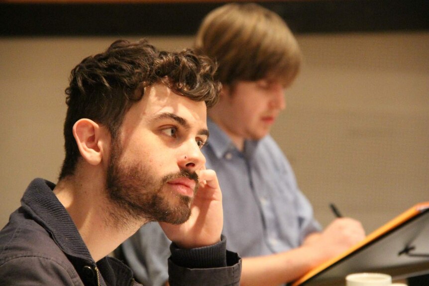 Composer Alex Turley watches the Tasmanian Symphony Orchestra rehearse.
