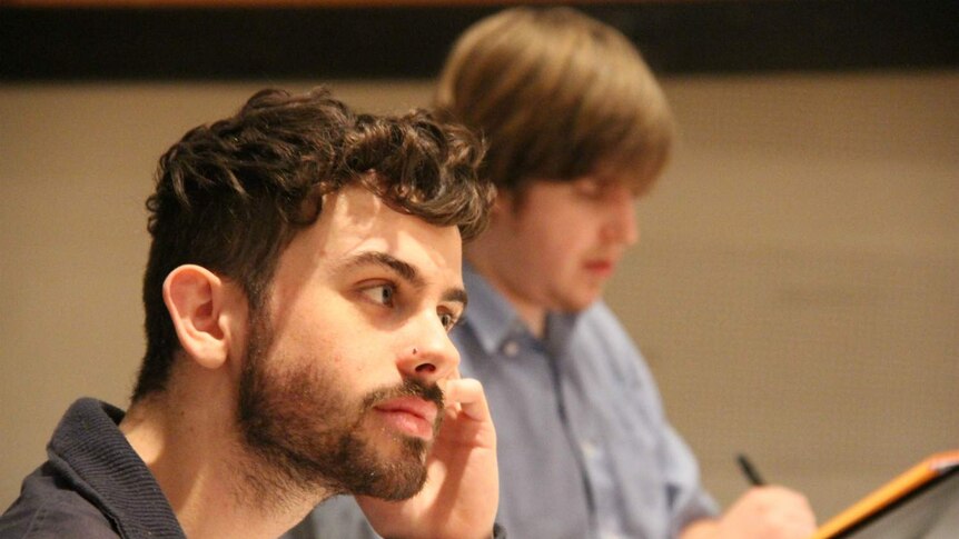 Composer Alex Turley watches the Tasmanian Symphony Orchestra rehearse.