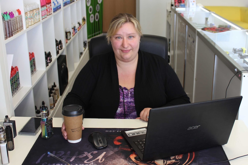 Narissa Hansen sitting in her desk at her store.