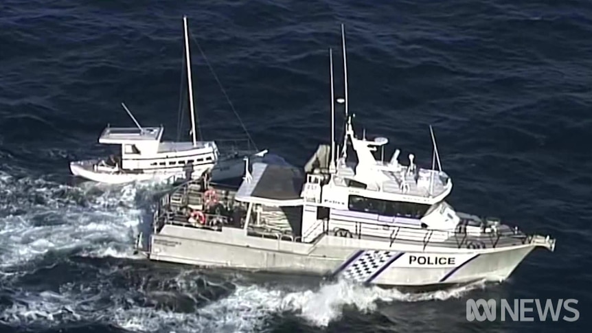 A police boat alongside a smaller fishing vessel in the ocean off South Australia