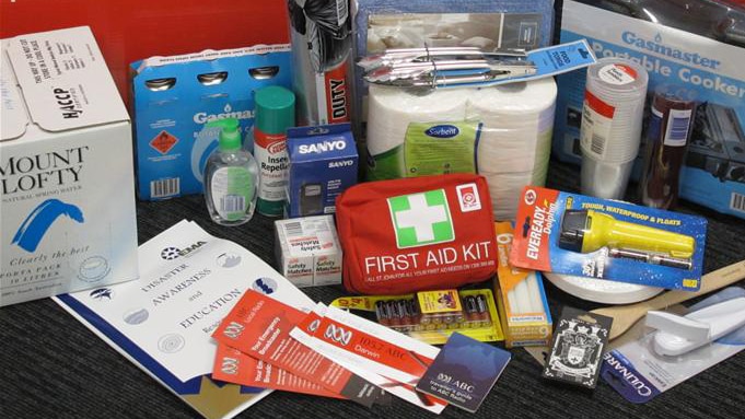 Photo shows first aid kit, torch, insect repellant, gas cooker and other survival kit essentials