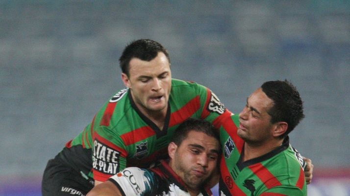 Maurice Blair is tackled by a pack of Rabbitohs