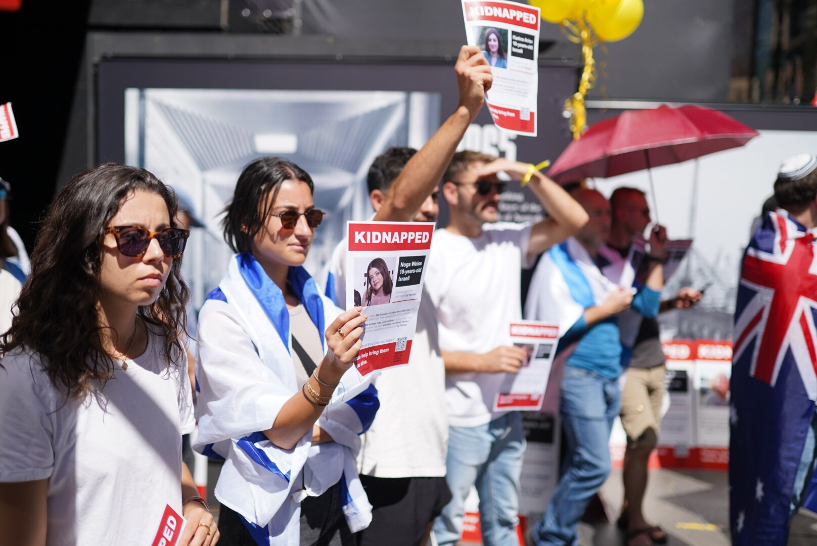 Protesters hold hostage posters at pro-Israel rally