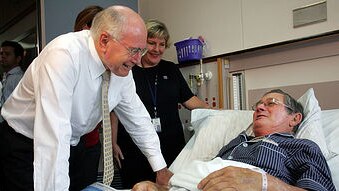 File photo: Howard speaks with a patient at Cairns Private Hospital, November 15, 2007 (Getty Images: Lisa Maree Williams)