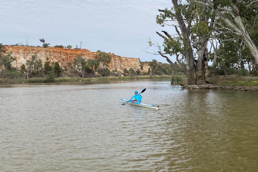 A man kayaking on the river.