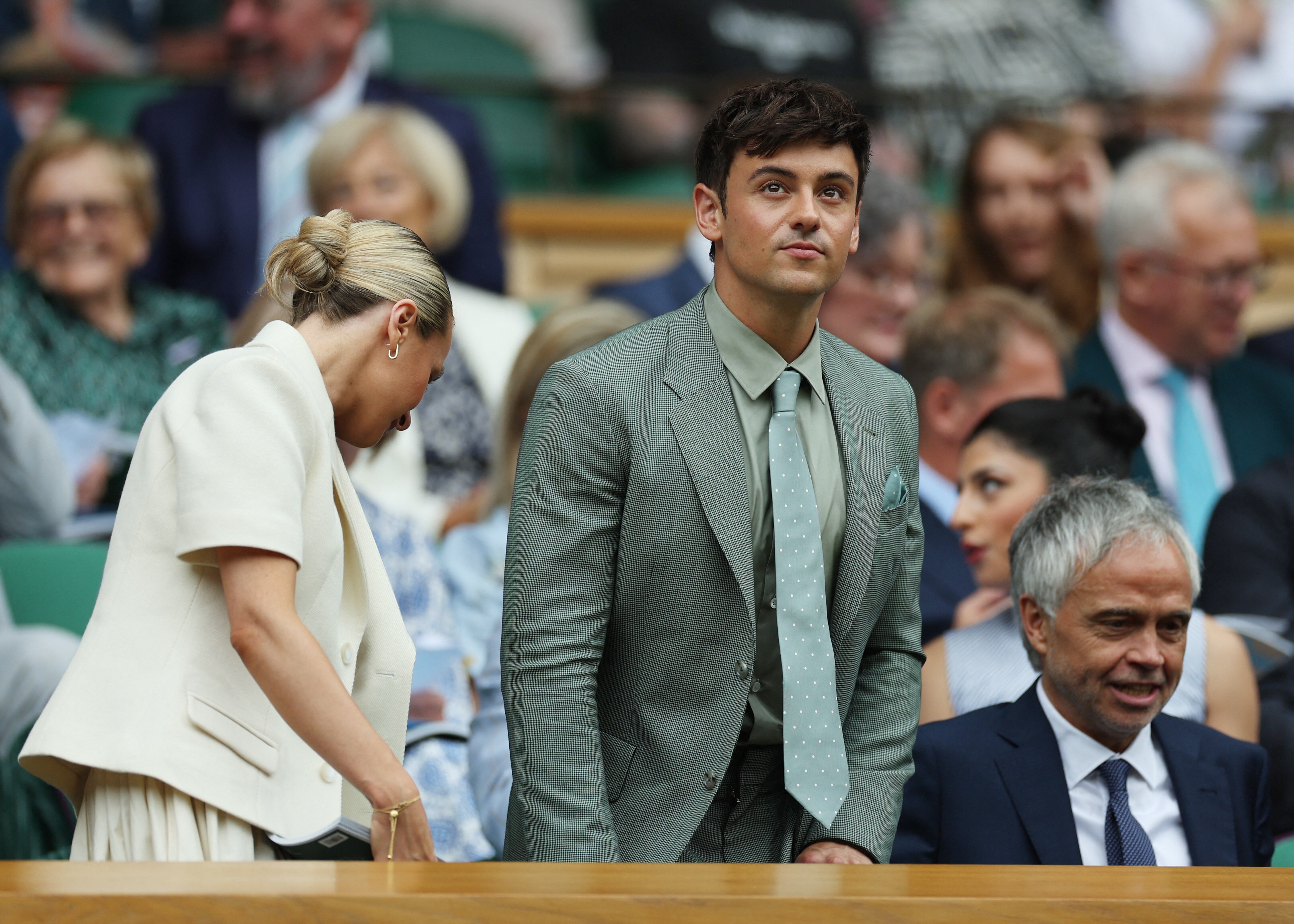  in a sage green suit Olympic diver Tom Daley takes his seat in the Royal Box on Centre Court. 
