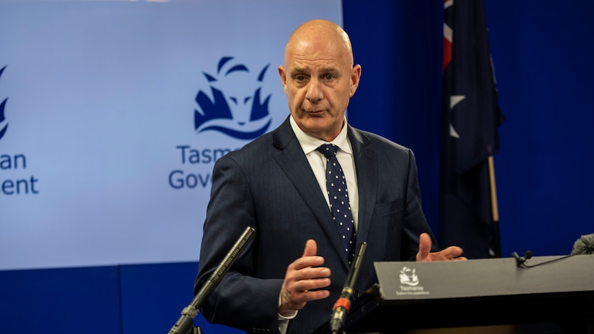 Tasmanian Premier Peter Gutwein A bald man in a suit at a press conference.