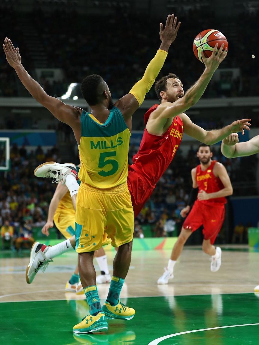 Patty Mills of Australia tries to take a charge against Sergio Rodriguez at the 2016 Rio Olympics.