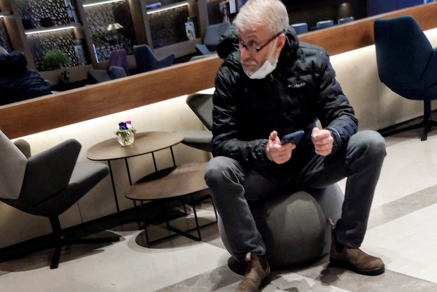 Roman Abramovich sitting in an airport lounge. 