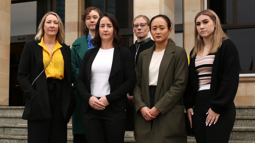 A group of six women pose for a photo outside the front entrance to the WA Parliament.