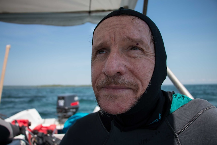 Professor Peter Harrison on a boat at Magsaysay Reef in the northern Philippines.