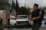 An Israeli border police officer stands guard at the scene of a hit-and-run attack in Jerusalem