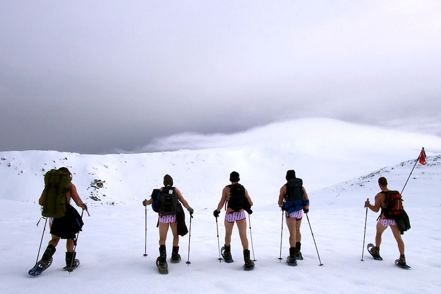 Five climbers at the top of Mt Kosciuszko in cossies