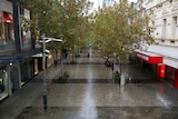 A rainy Hay Street Mall pictured from above with a lone woman walking along.