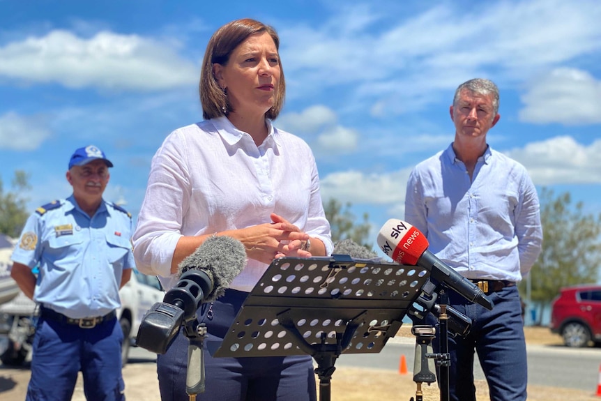 Deb Frecklington speaking at a lectern at a media conference, with Tim Mander on her right.