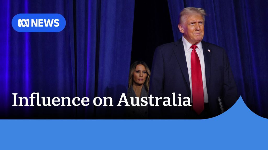 Influence on Australia: Donald Trump smiles as he emerges on stage from behind thick blue curtain. 