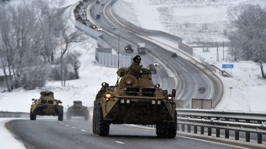 A Russian tank driving down a snowy road.