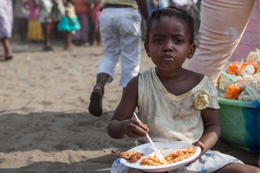 Liberian girl eats at Christmas party