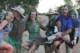 Six people, smiling and covered in food dye