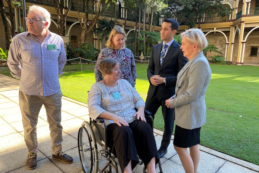 Patricia Clayton - in wheelchair - with Catherine Santagiuliana, David Crisafulli and Ros Bates on the parliamentary green
