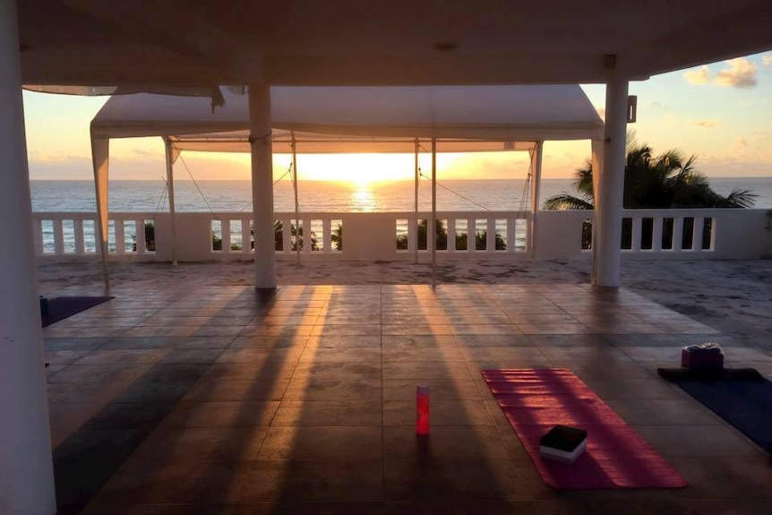 A tent looking out on a sunrise over the ocean