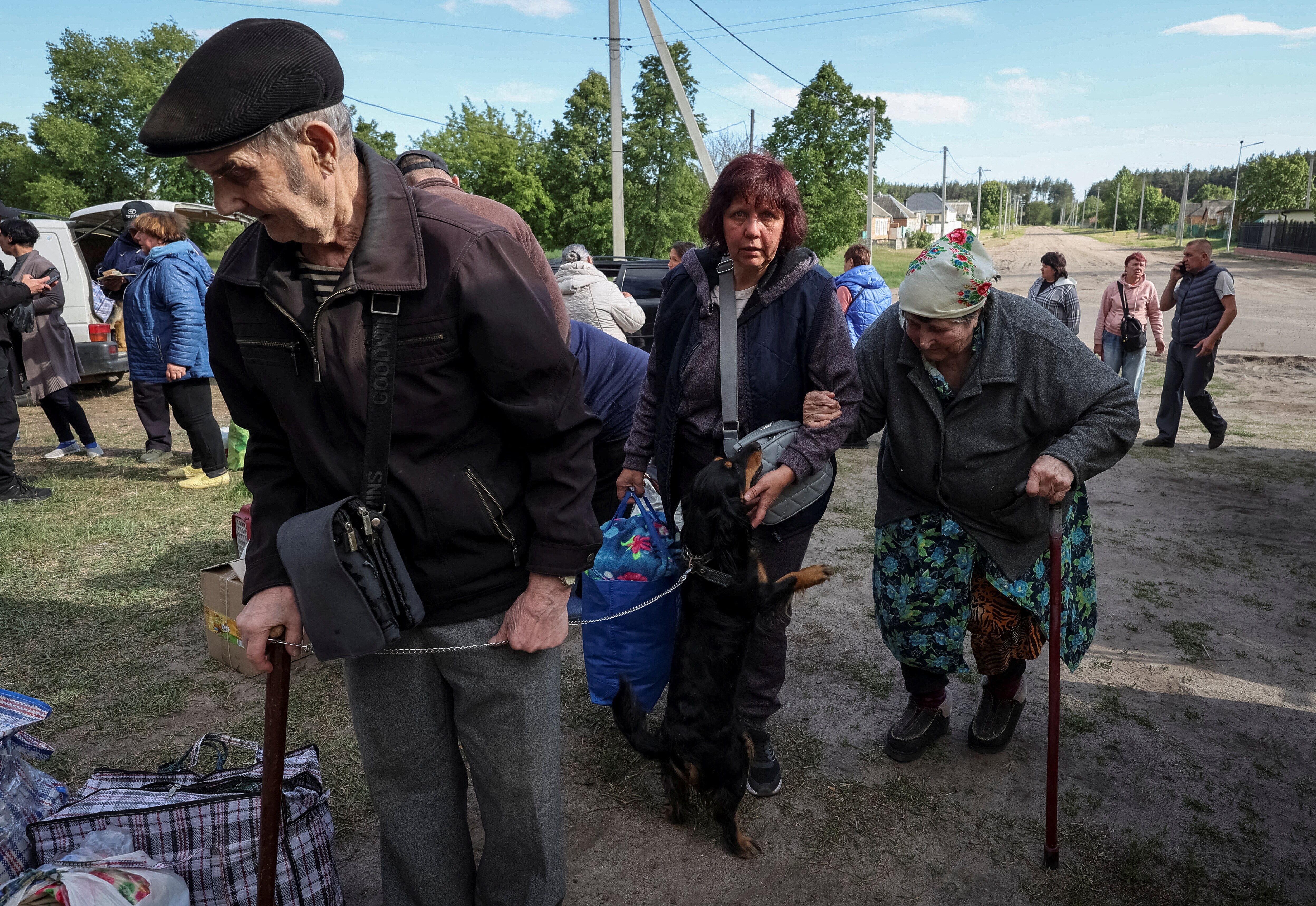 Residents from Vovchansk and nearby villages wait for buses.