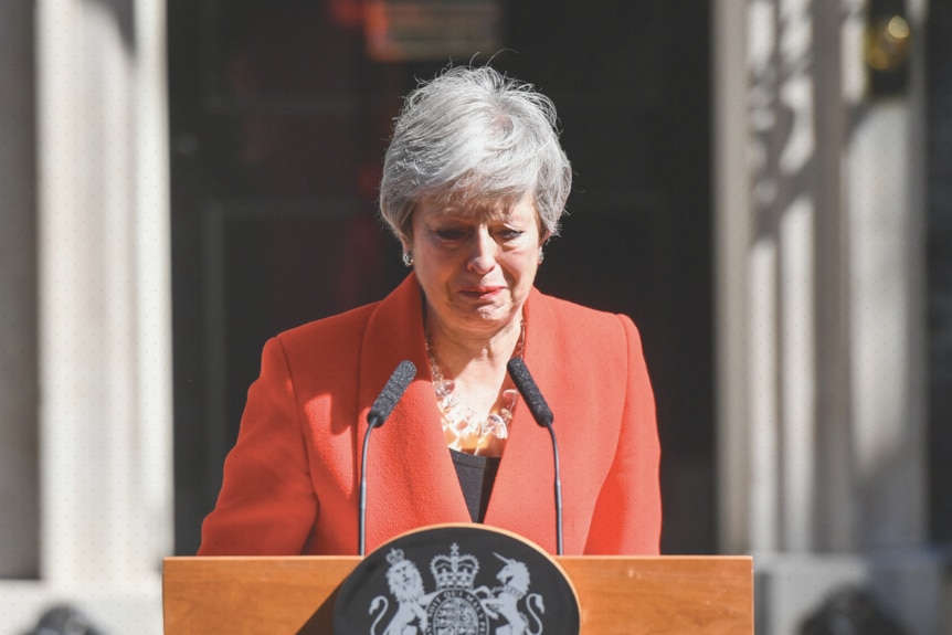 Theresa May stands behind a lectern in front of Downing Street.
