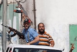 Libyan rebels drive through the oil port of Zawiyah.