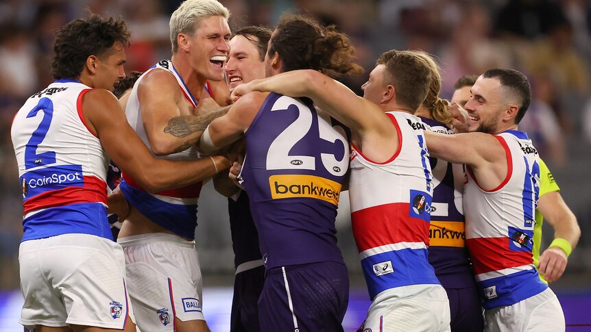 Rory Lobb has a wrestle with Alex Pearce as other Bulldogs players get involved