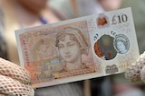 People in period costume pose with the new 10 pound note featuring Jane Austen