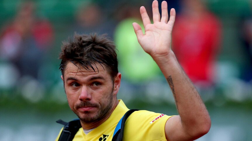 Switzerland's Stanislas Wawrinka waves to the crowd after losing his first-round match at the French Open.