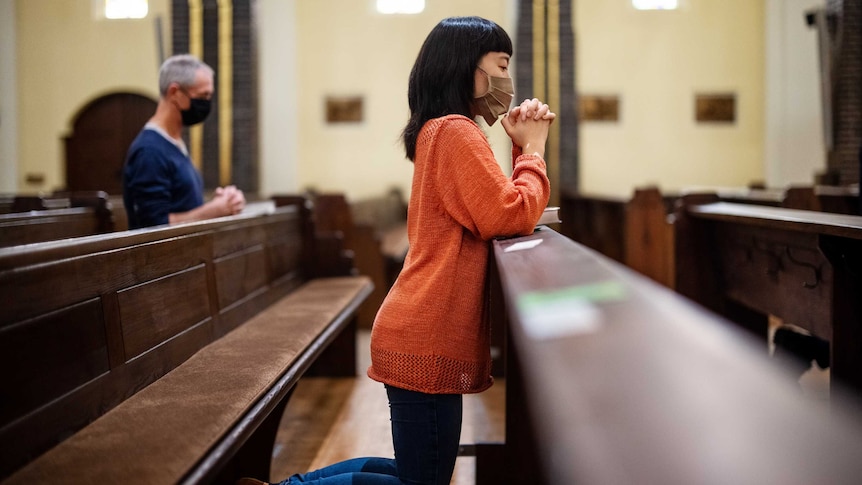 People praying in church during the COVID-19 restrictions.