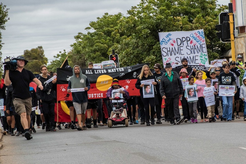 Marchers walk through the centre of Kalgoorlie ahead of the rally.