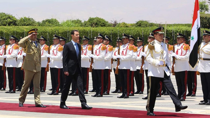 Syrian president Bashar al-Assad (C) arriving for a swearing-in ceremony at the presidential palace in Damascus
