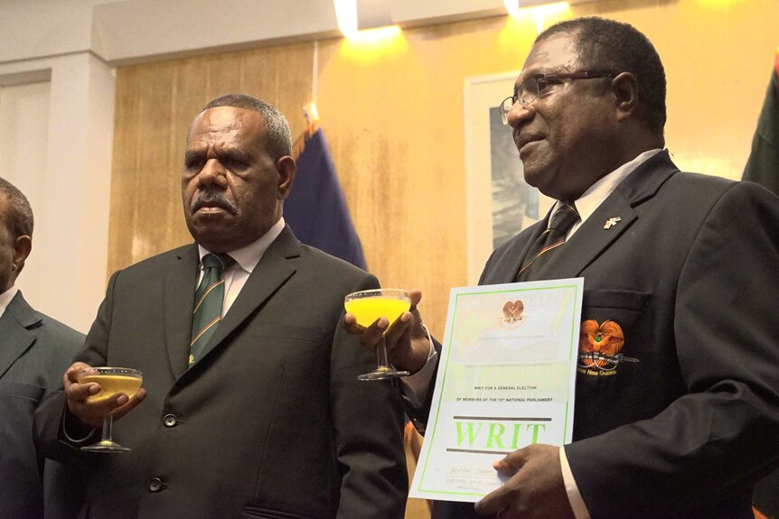 PNG Governor-General Sir Bob Dadae, left, and Electoral Commissioner Patilias Gamato holding glasses of juice