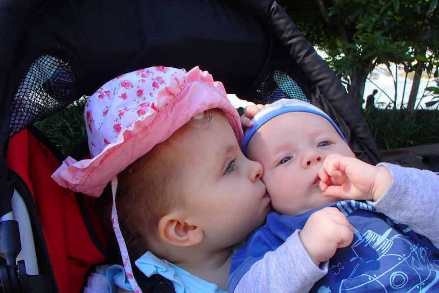 Eleanor Holland kisses her baby brother Tobias