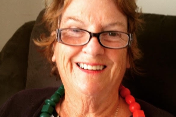 A smiling, older woman wearing spectacles.