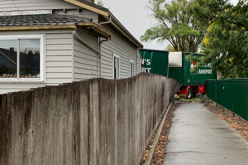 A B-double truck crashed into the front of a house.