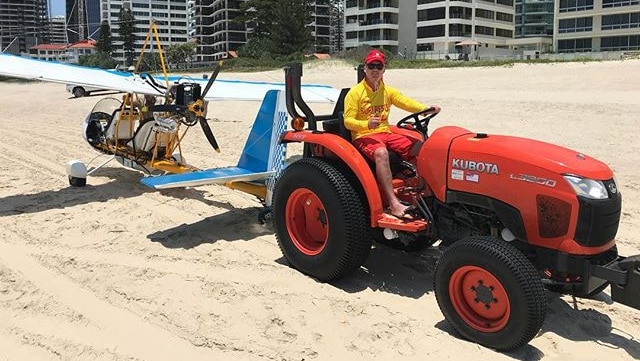 Surf lifesavers had to tow a plane after it made forced landing on crowded Surfers Paradise Beach after its engine failed.